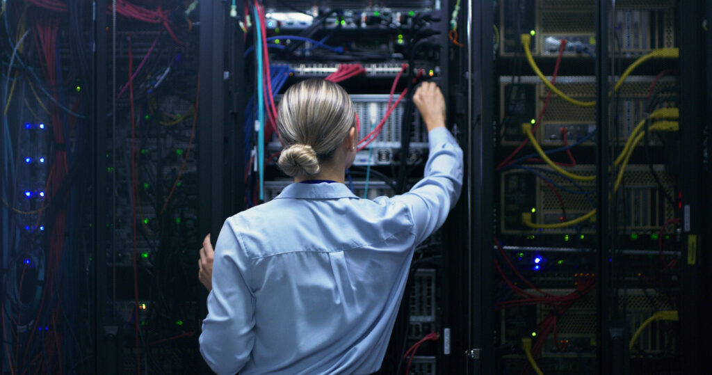 Technician working on server equipment inside a data center