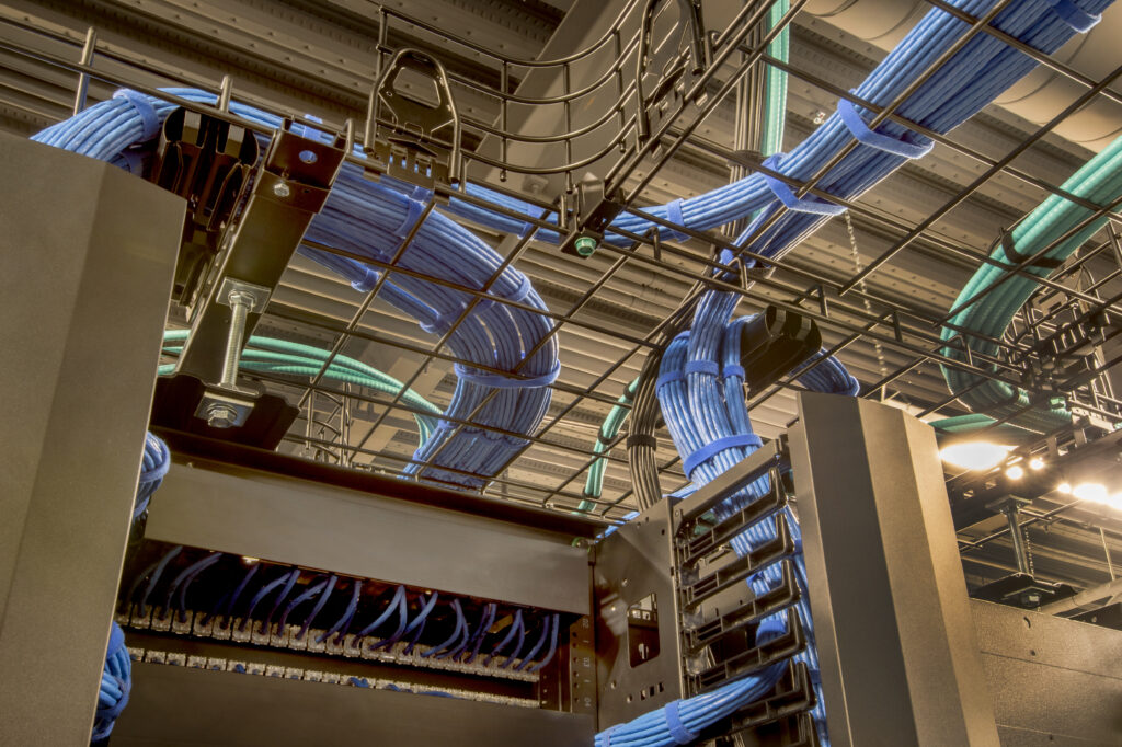 Network cables organized in overhead trays inside a data center