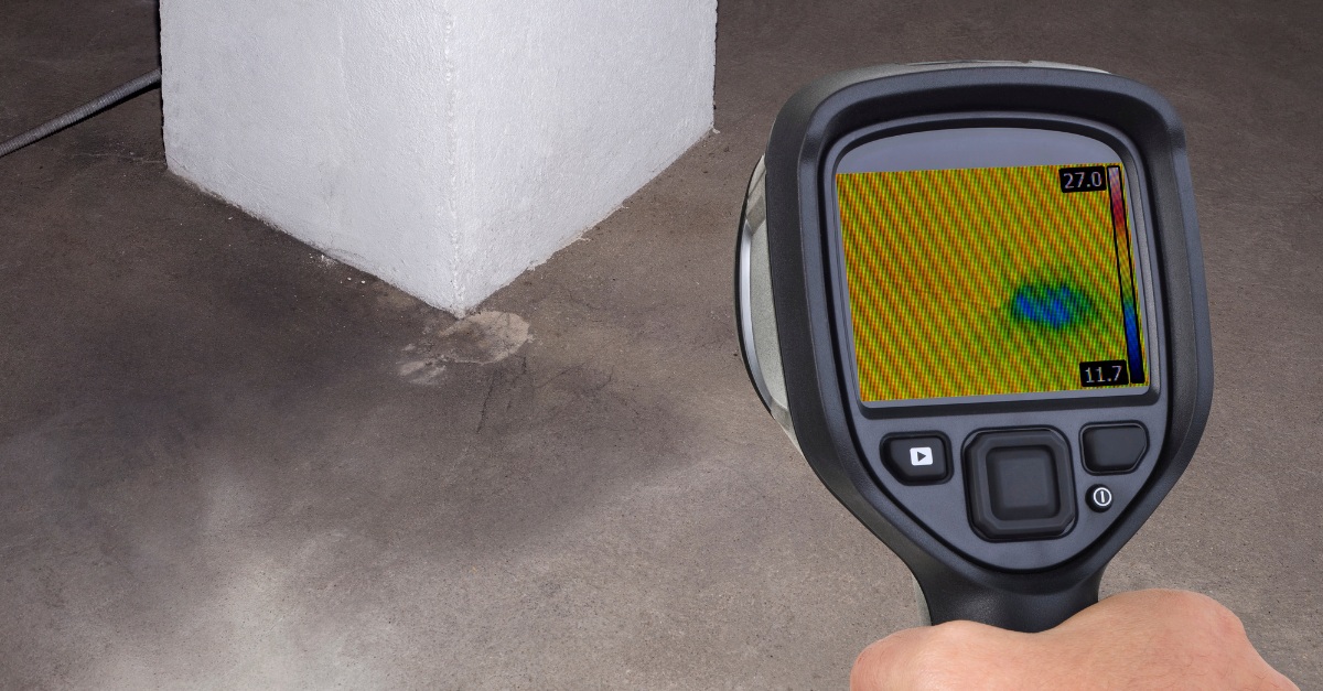 Handheld thermal camera detecting moisture at base of concrete column